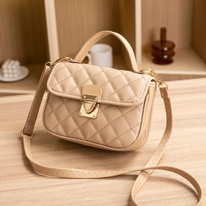 Quilted Kelly handbag in beige with golden heart lock and adjustable shoulder strap