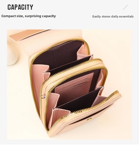 Detail view of pink leather crossbody bag with dual zippers and multi-layer inner slots