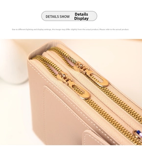 Detail view of pink lychee leather phone bag showing double gold zippers and stitching