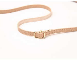 Detail of adjustable khaki leather shoulder strap with gold buckle and fine stitching