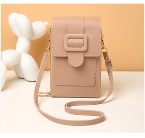 Detailed view of lychee texture leather mobile phone bag with golden hardware and square buckle