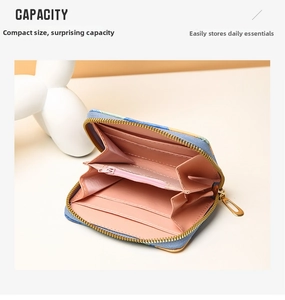 Internal view of a blue embroidered wallet featuring pink card slots and a zipper coin pocket