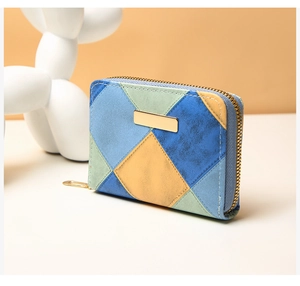 Detail of color-block patchwork coin purse with matte synthetic leather and gold zipper