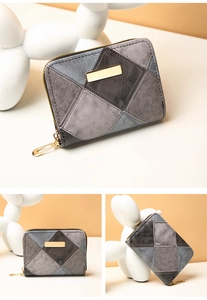 Macro shot of patchwork quilted wallet featuring grey tones and gold zipper detail