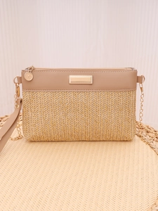 Detail showing the woven texture and faux leather top with gold chain strap