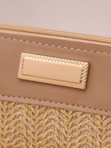 Close-up of woven straw texture and leather splicing with gold metal nameplate