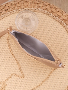 Macro view of woven shoulder bag with golden chain strap and gray fabric lining