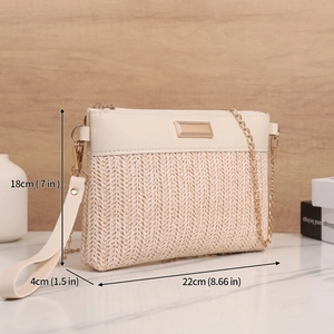 Chic woven beige crossbody bag with gold chain and dimensions 22x18x4cm on marble