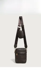 Detail of brown shoulder bag with geometric texture, gold hardware, and round coin purse