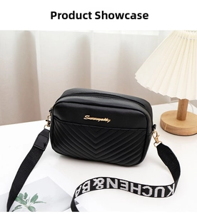 Close-up of black V-quilted faux leather bag with wide logo-printed webbing strap