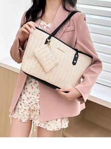 Fashion straw tote bag set with black leather straps styled on pink blazer outfit