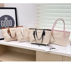 Detail of woven straw tote bags in four colors with matching coin purses on a display