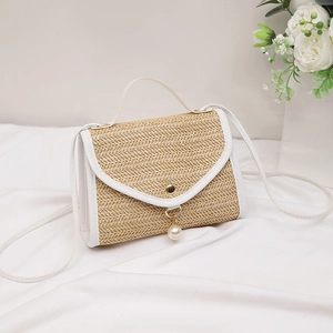 Fashionable straw crossbody bag with pearl tassel and leather trim in a summer style