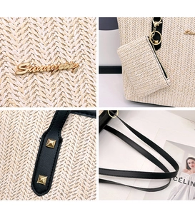 Detail of straw woven tote showing gold logo, rivet strap, and inner pouch accessory