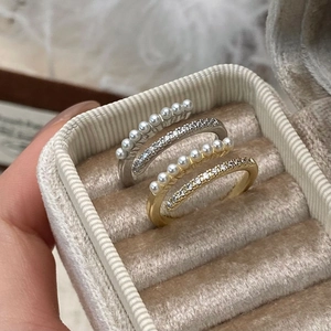 Elegant french style pearl and zircon open rings in gold and silver set on a velvet box