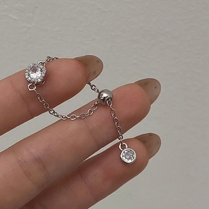 Detail of silver chain ring featuring a square zircon main stone and adjustable slider