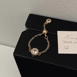 Macro view of adjustable gold chain ring with square-framed zircon and sliding buckle