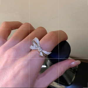 Elegant bow-shaped open ring with micro-pave cubic zirconia in silver finish