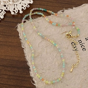 Detail of colorful faceted beaded necklace with golden adjustable lobster clasp and chain