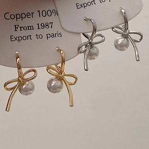 Elegant 100% copper bow pearl earrings in gold and silver finish on display card
