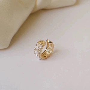 Elegant gold C-shaped ear cuff with white pearls and sparkling zircons for non-pierced ears