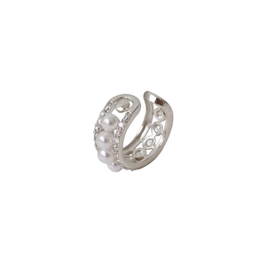 Detailed macro view of silver ear cuff with pearls and pavé cubic zirconia inlay