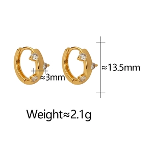 Macro detail of 18K gold huggie earrings showing dimensions and 3-prong zircon setting