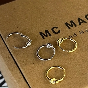 Minimalist geometric knot hoop earrings in polished gold and silver metal finishes