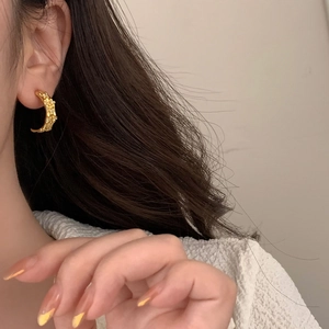 Elegant gold C-shaped bamboo texture earrings with micro-set zircon stones on model