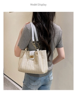 Straw shoulder bag for women with white leather strap and gold clasp on a model