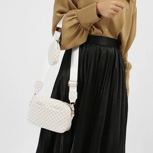 White vintage crossbody bag with brown circular pattern and detachable small round pouch