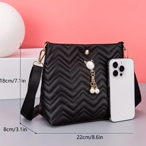 Quilted crossbody bag detail with pearl cat pendant and size scale comparison