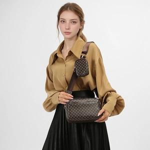 Detail of printed crossbody bag set with wide strap on yellow shirt and black skirt
