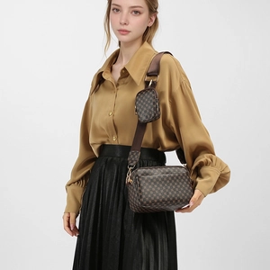 Detailed view of brown floral vintage 2-in-1 crossbody bag with mini coin purse attachment