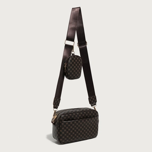 Detail of vintage patterned crossbody bag with a round coin purse on wide strap