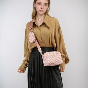 Detail of pink monogram crossbody bag with wide strap and round coin purse attachment