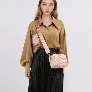 Detail of pink crossbody camera bag set with matching round pouch on wide fabric strap
