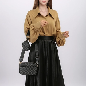 Detail of 2-in-1 crossbody bag set with geometric grid pattern and gold hardware