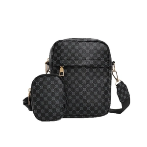 Modern black shoulder bag with geometric pattern and round coin purse on wide strap