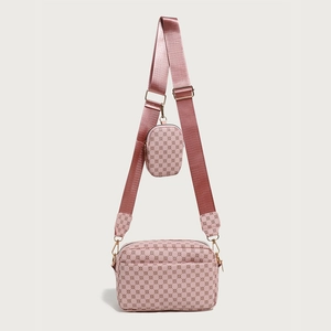 Detail of pink crossbody bag with vintage logo pattern and mini pouch attachment