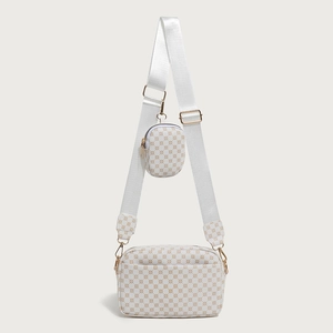 Detail of white printed crossbody bag set with mini coin purse and gold hardware