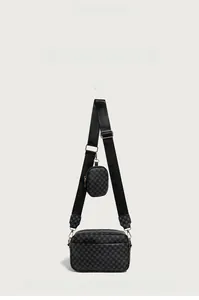 Detail view of black vintage monogram crossbody bag with small round coin purse attachment