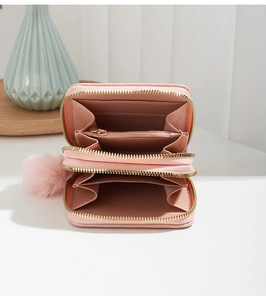 Pink quilted leather wallet with double zippers, multiple card slots and pompom charm