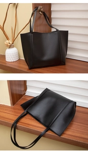 Détail du sac cabas noir minimaliste en similicuir sur une étagère en bois