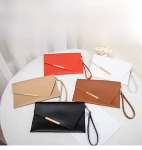 Detailed overhead view of minimalist envelope clutch bags in five different colors