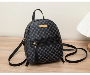 Close-up of black PU leather mini backpack with gold metal hardware and geometric pattern