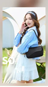 Detail of black leather shoulder bag featuring unique irregular wavy flap design