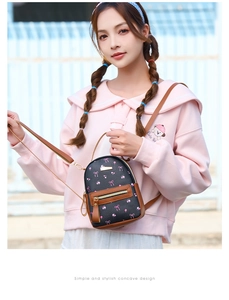 Detail of mini floral backpack with pink bows and brown leather straps on a model