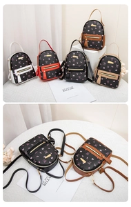 Detailed view of mini PU leather backpacks with pink bow prints and zipper pockets