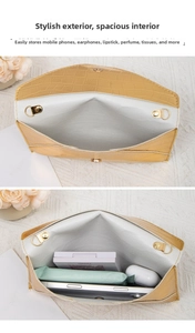 Detail view of yellow faux crocodile clutch showing internal capacity for daily essentials